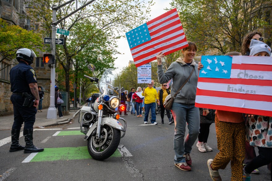 No Kings protestors march through the streets of New Haven.