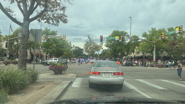 Police cars line a busy downtown street