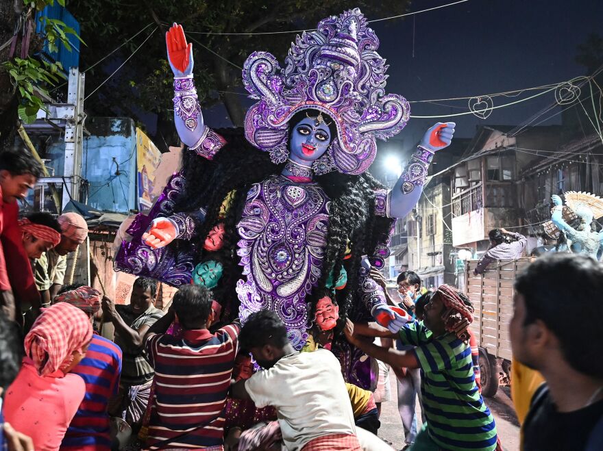 Laborers transport an idol of the Hindu goddess Kali to a place of worship on the eve of Diwali at Kumortuli, the traditional potters' quarter in northern Kolkata on Wednesday.