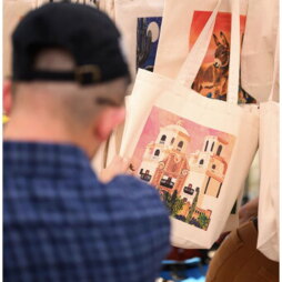 Person viewing handmade tote bag.