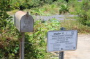 An image of burned-out mailbox in front of a lot where a home once stood in Lahaina, Maui. 