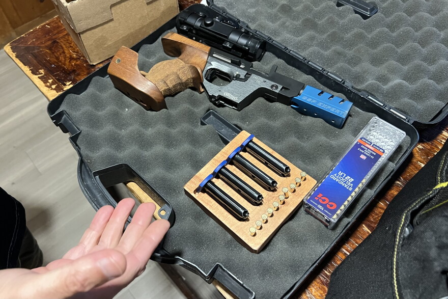 A member of the Falmouth Rod & Gun Club shows a semiautomatic pistol he uses in target matches.