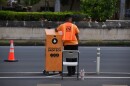 Staff member waits next to drive-by ballot drop box at Honolulu Hale.