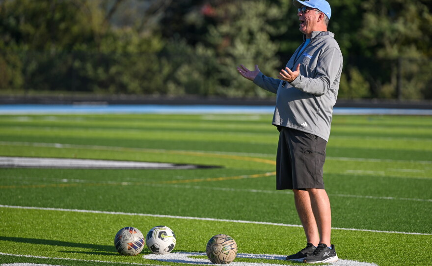 Wilkes-Barre Area Head Coach Jack Nolan jokes with a player during practice.