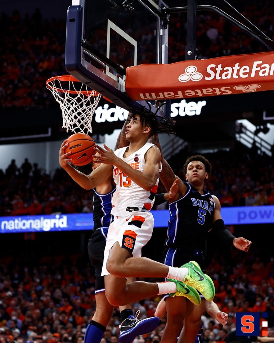 Benny Williams (#13, white) airborne en route to a reverse layup against Duke.