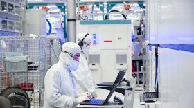 A photo from November 2021 shows employees in cleanroom "bunny suits" working at Intel's D1X factory in Hillsboro, Oregon. The company's presence in the state has made semiconductors Oregon's most valuable export.