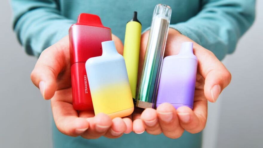 Person holding vapes in hands. 