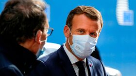 French President Emmanuel Macron wearing a face mask arrives ahead of a two days European Union (EU) summit at the European Council Building in Brussels.