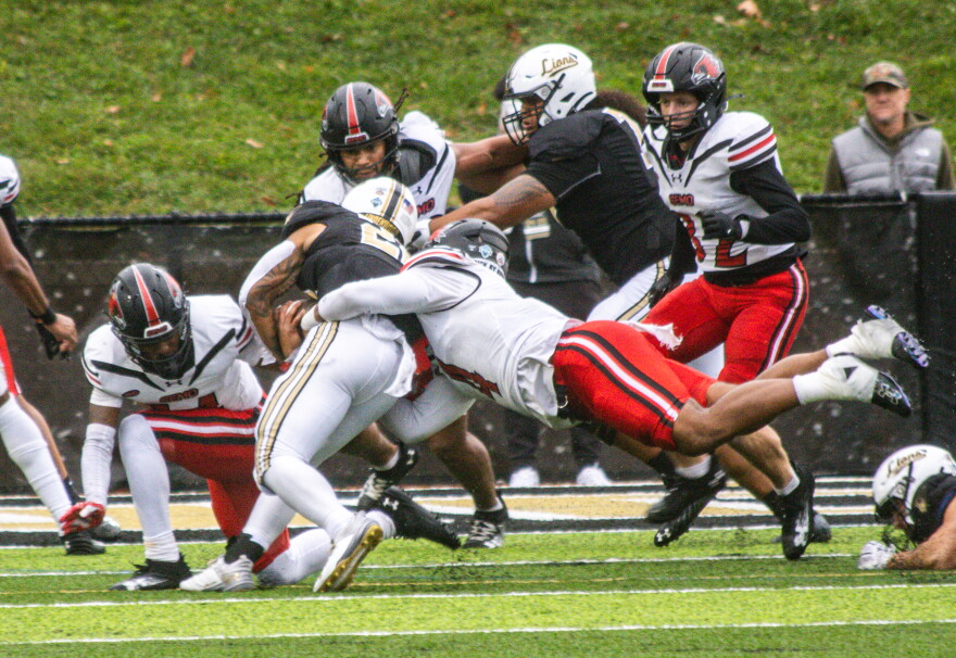 Defensive linebacker McCoy Casey tackles a Lindenwood player down on a rainy game day on Nov. 9, 2024, at Harlen C. Hunter Stadium at Lindenwood.