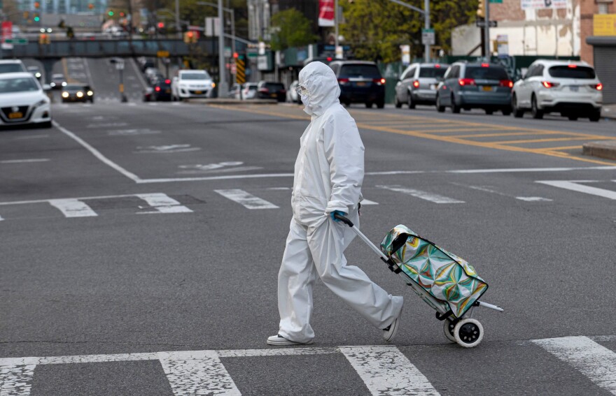 A woman wearing a hazmat suit and goggles pulls her grocery cart in the streets in Queens, a borough of New York City, amid the coronavirus pandemic on  April 20, 2020 in New York City.(Johannes Eisele/AFP via Getty Images)