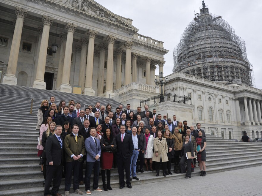 A group including <em>Top Chef</em> stars Tom Colicchio and Padma Lakshmi and several dozen chefs from around the country pose for a photo on the Capitol steps as they came together for a day of action and advocacy on the Hill.