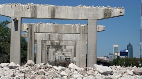 demolition rubble in the foreground with skyscrapers in the distance