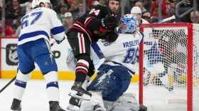 Hockey players around the goalie