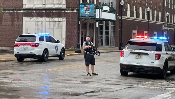 An unidentified officer is armed with an automatic weapon outside Signature School after an apparent false report of someone with a gun inside the downtown school
