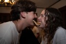 Two Salt Company students bite opposite ends of a pancake.