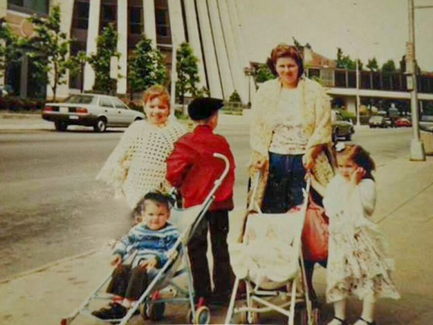 Chef Wilfredo Arguinzoni, in the stroller, walks in downtown Rochester with his mother and siblings once upon a time.