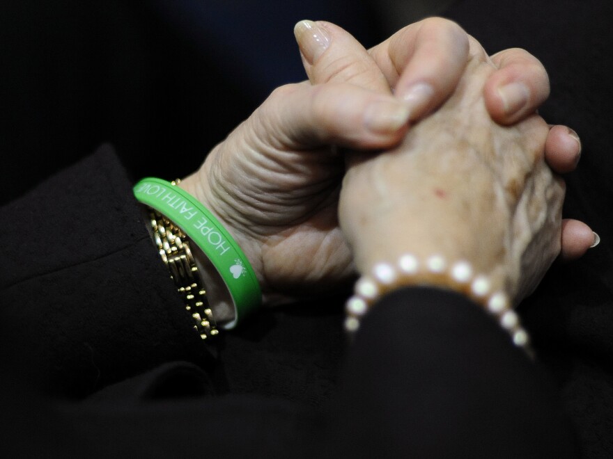 Newtown Schools Superintendent Janet Robinson wears a bracelet reading Hope, Faith, Love in the school colors of Sandy Hook Elementary during Gov. Dannel Malloy's State of the State address at the Capitol in Hartford, Conn., on Wednesday.