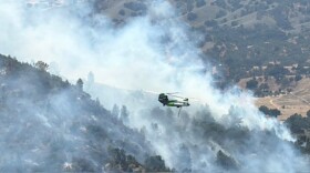 A helicopter making a drop on the Lake Fire.