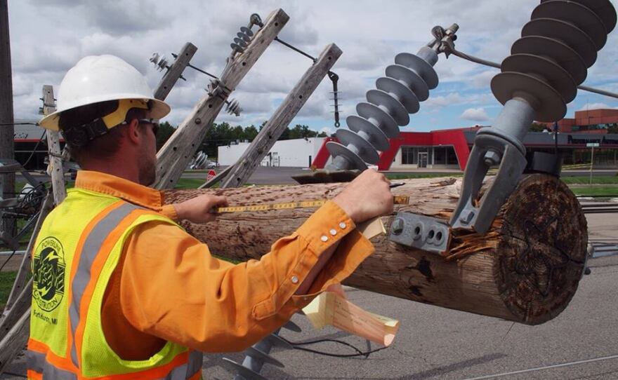 Work being done on Orchard Lake Rd where a power pole fell.