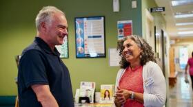 Sen. Tim Kaine speaks with Sinclair Health Clinic's executive director, Dr. Mercedes Abbet, in Winchester on Monday.