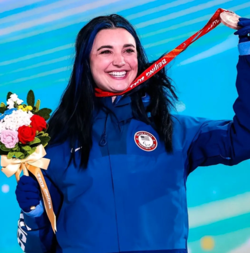 Snowboarder Brenna Huckaby clutches bronze medal for snowboard cross at the 2022 Paralympics in Beijing. She would go on to win a gold medal in banked slalom days later.