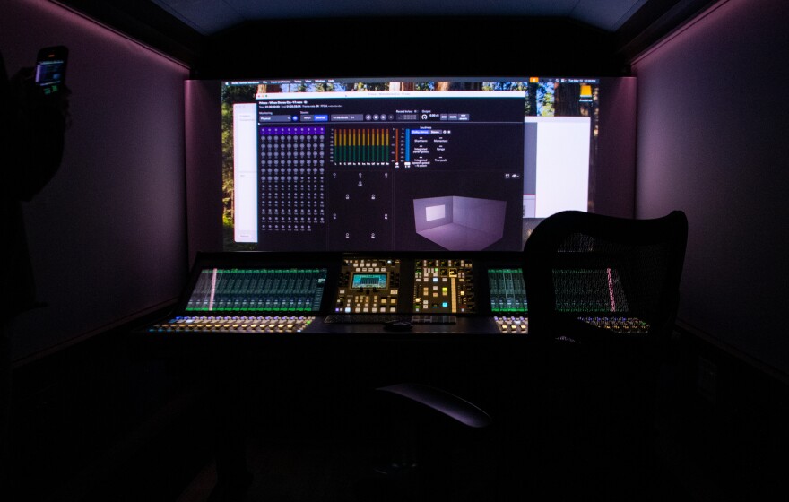 Inside the mobile recording booth, speakers are hidden inside nearly every surface and a large screen and connected sound board allow for mixing.