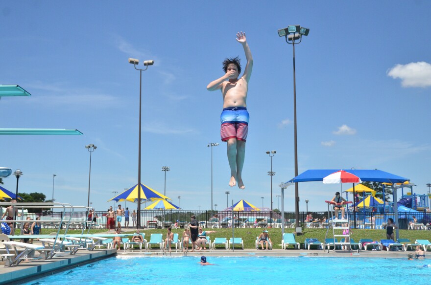 Carl Bradfute, an 11-year-old from California, shows off his only trick on the diving board — a 180.
