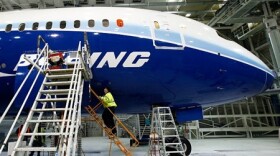 A worker climbs aboard a 787, the first of the model scheduled to fly, at the plant in Everett, Wash, in April 2009. Company officials have announced another delay in the first delivery of the new plane, an event postponed to July.