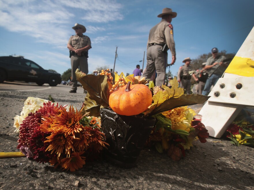 Flowers rest beside a police barricade near the First Baptist Church of Sutherland Springs, Texas. Authorities say the victims' ages range from just 18 months to 77 years old.