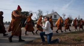 Audrie Pearce greets Buddhist monks who are participating in the "Walk For Peace," Thursday, Jan. 8, 2026, in Saluda, S.C. (Allison Joyce/AP)