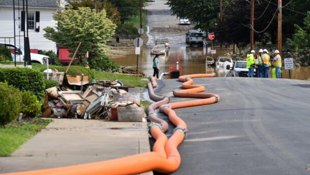 Hoses pump water out of a flooded neighborhood in Scranton's Keyser Valley after a deadly flash flood in September 2023.