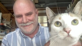 EKU Animal Studies and Psychology Professor Bob Mitchell with one of his four cats