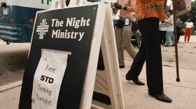 A sign is posted outside The Night Ministry bus on Aug. 9, 2000 in the Uptown neighborhood of Chicago, informing citizens of the free STD testing offered by The Outreach and Health Ministry program. The Night Ministry reaches out to individuals who are living on the streets, many of whom do not have access to social services. (Tim Boyle/Newsmakers/Getty Images)
