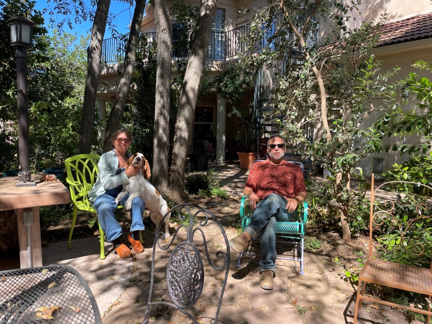 Farmers Tina Rasnow and Brian Rasnow with their two-year-old basset hound Opie on their ranch in Newbury Park. The ranch is perched on a mountain top 1,600 feet above sea level.