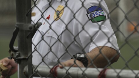 A GEO Group guard closes a door at a U.S. Immigration and Customs Enforcement detention center during a media tour on Dec. 16, 2019, in Tacoma, Washington.