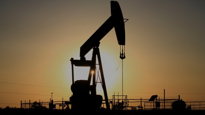 A pump jack operates at sunset in the Permian Basin near Loving, N.M., on Tuesday, May 20, 2025.