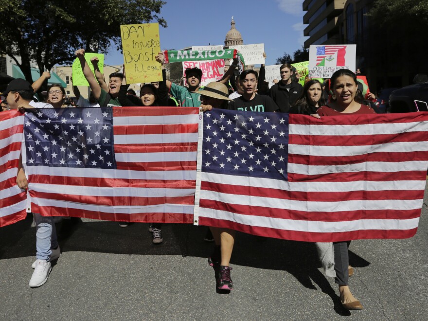 Demonstrators march through downtown Austin, Texas, on Thursday. Protesters are targeting recent immigration raids around the country.