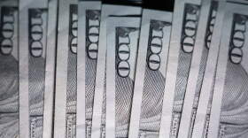 U.S. $100 bills are seen. (Matt Slocum/AP)