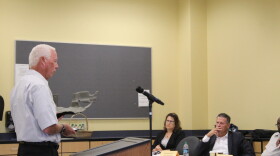 Elkhart-based FlexForm Technologies CEO Gregg Baumbaugh shows the study committee one of the car parts his company makes using hemp.