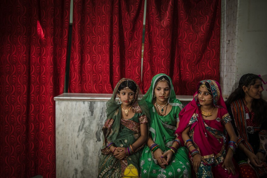 Three students from the Veerni Institute are dressed up for a dance performance in honor of their teachers. Nearly half of the girls at the Institute were married as children.