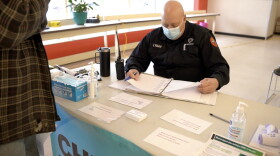 Steve Lyday, public health preparedness and response coordinator for Morgan County, works the check-in table at the Martinsville COVID-19 vaccination clinic.