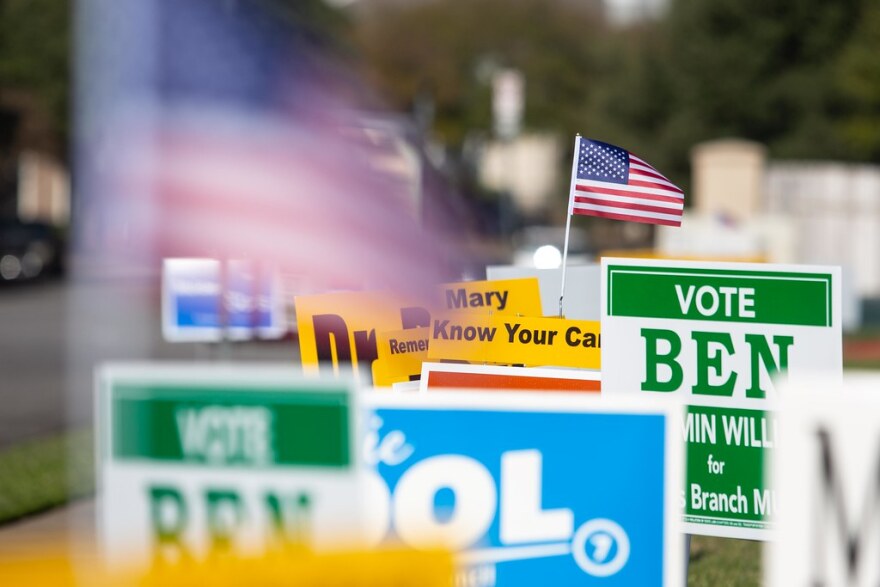 A bunch of campaign signs on Election Day. 