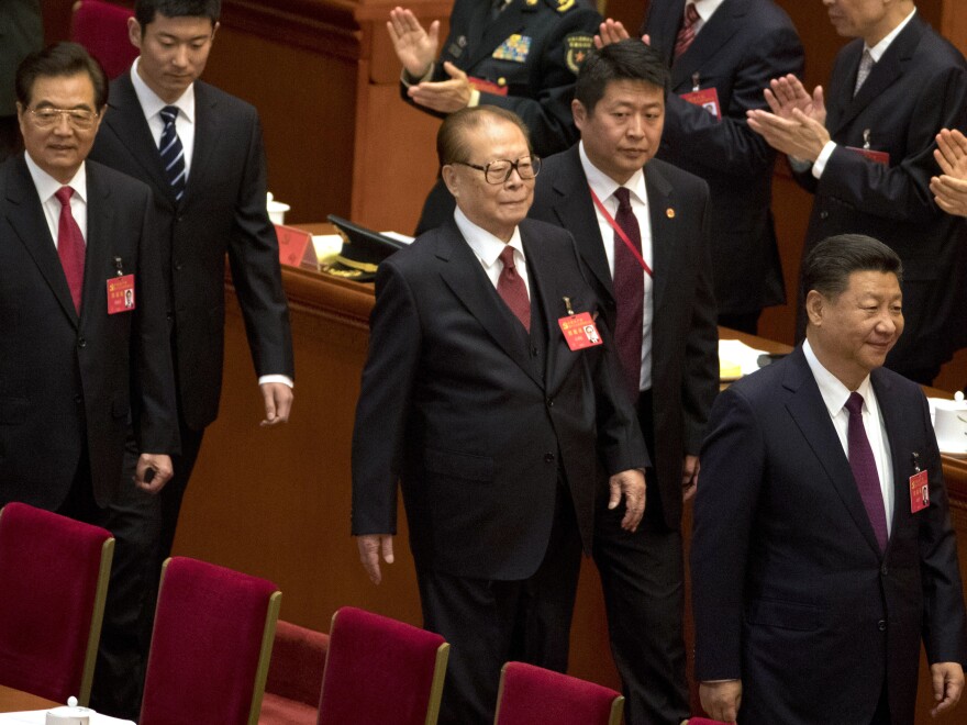 Chinese President Xi Jinping, (enters) enters the opening ceremony of the 19th Party Congress ahead of his predecessors Jiang Zemin (center) and Hu Jintao (left) on Wednesday.