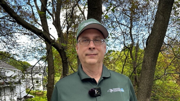 Regional DEC forester Tim Wenskus shows two Norway maple leaves infected with tar spot.