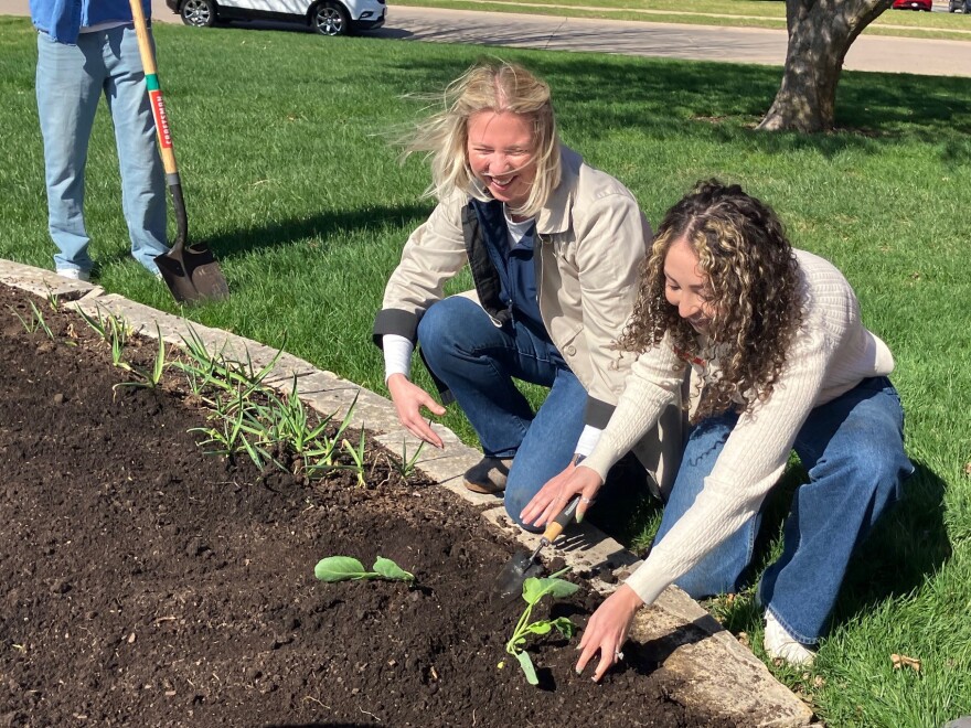 Tayler Louscher (left), University of Illinois Extension educator, and Samantha Culver, Scott County director for Iowa State University Extension, plant some cabbage for GIFT Gardens outside the Scott County Extension office in Bettendorf on Monday, April 6, 2026.