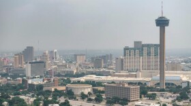 A hazy skyline view of downtown San Antonio