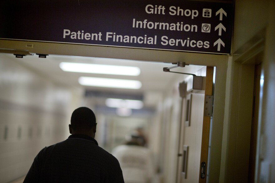 FILE: A sign points visitors toward the financial services department at a hospital.