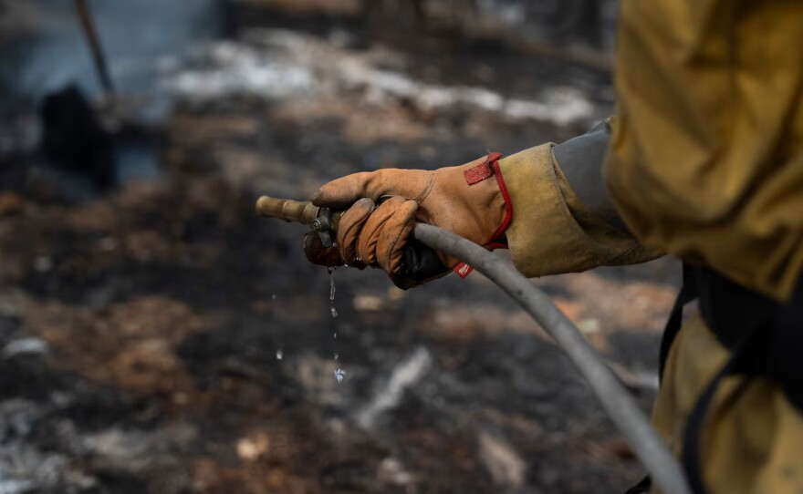 A firefighter works the line.