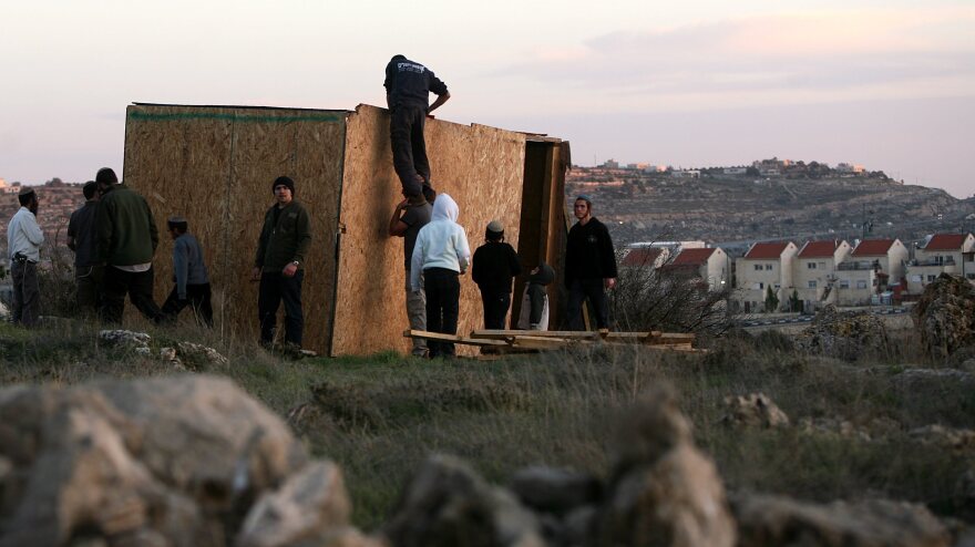 Jewish settlers from Kiryat Arba and Kharsina in the West Bank start to rebuild houses at a nearby unauthorized outpost, on Feb. 21. The Israeli government considers the outposts illegal and occasionally tears them down.