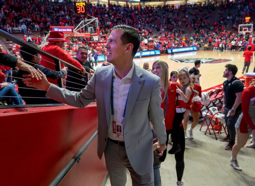 UNM Athletics Director Fernando Lovo greets fans as he leaves the Pit after he and his family were introduced during a Dec. 4, 2024 game against San Jose State. Eddie Moore